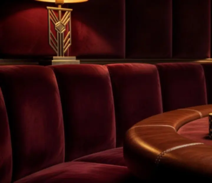 Private poker lounge ambience with velvet panels, pendant lights, and a felt poker table