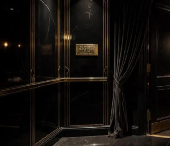 Dimly lit lounge entryway at Knave & Kitchen with velvet walls and a gold-detailed door leading to the card room