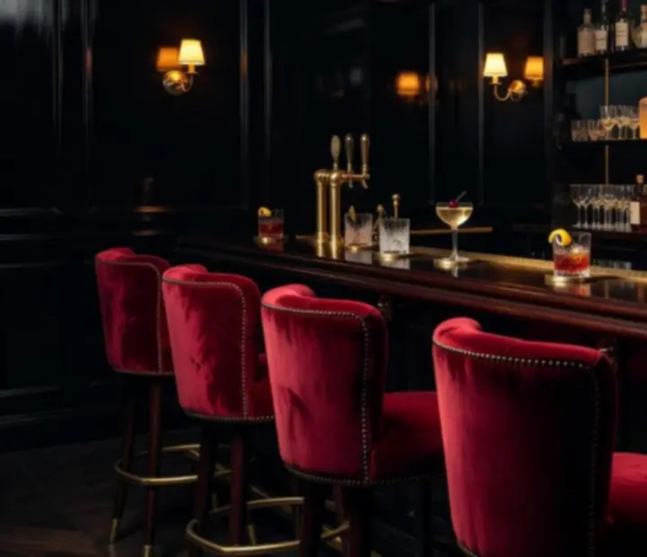 Mood-lit speakeasy cocktail bar with velvet seating and a discreet poker table nearby